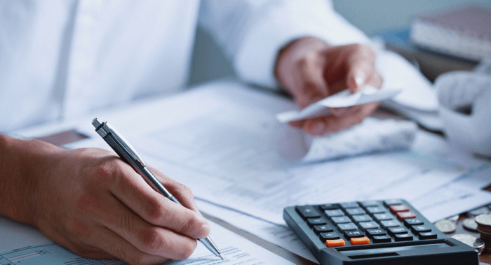 Man hand filling US tax form. tax form us business income office Financial document. Tax time.Tax concept. Close-up.